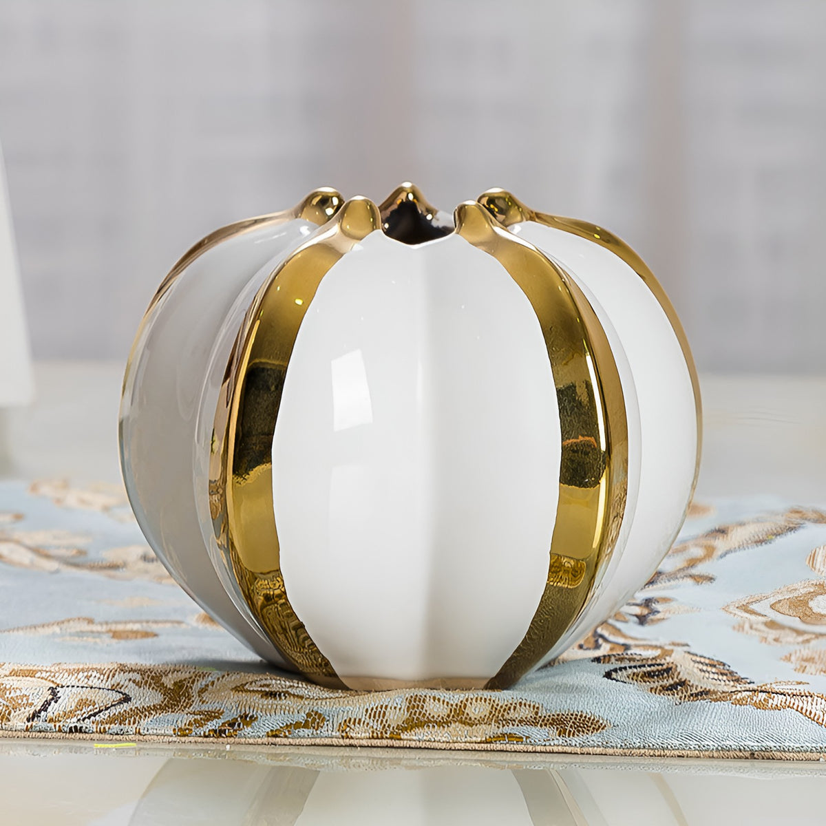 Small round white ceramic pumpkin vase with metallic gold trim